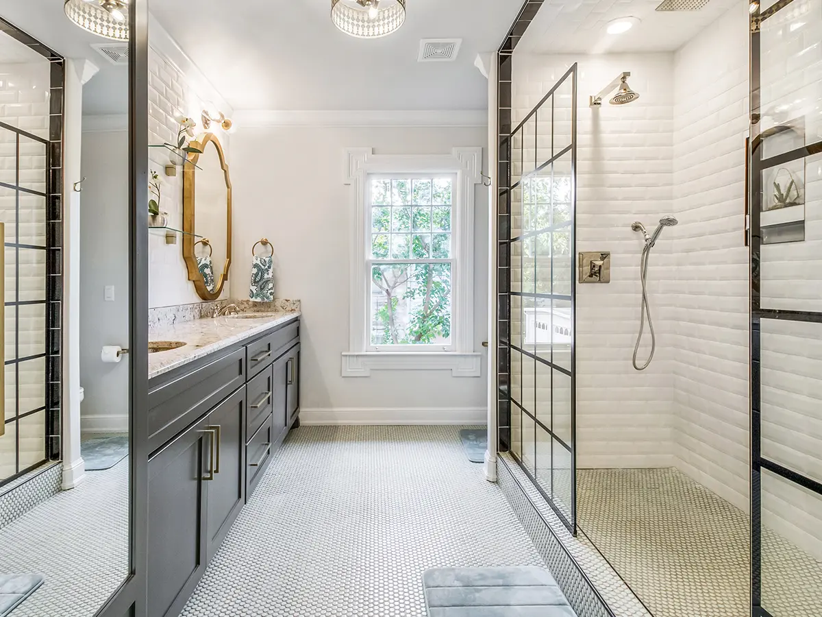 Modern large bathroom remodel with black vaity and framed glass walk in shower