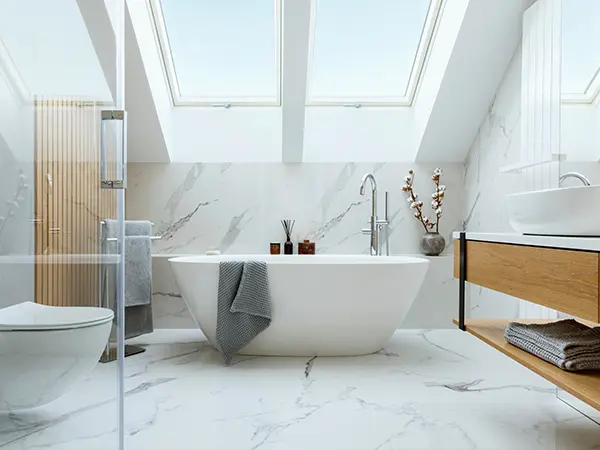 A bathroom remodeled with freestanding tub and glass shower