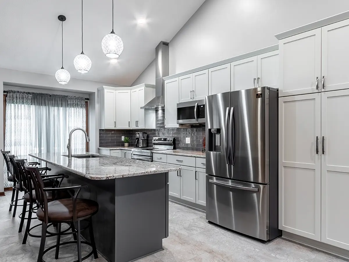 White new kitchen remodel with kitchen island and new appliances in Omaha, NE