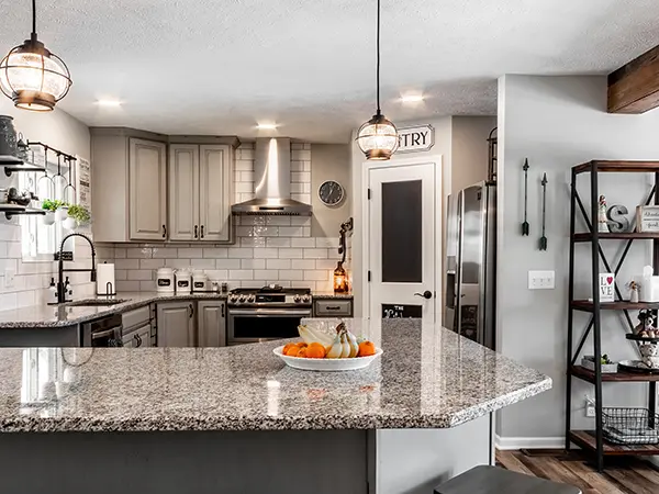 Remodeled kitchen with grey cabinets and mozaic countertops