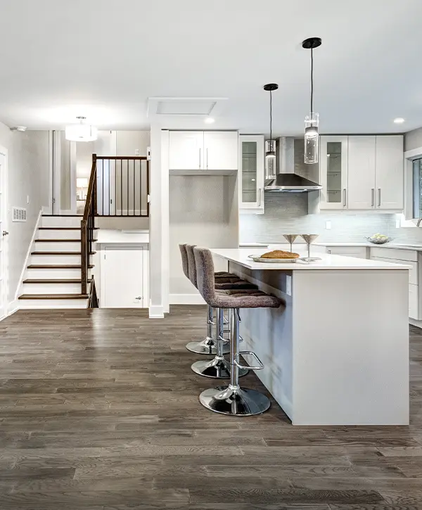 A basement remodel in La Vista with a small kitchenette and wood flooring