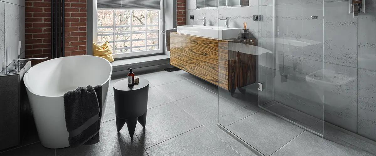 A modern bathroom with brick walls and tile floor