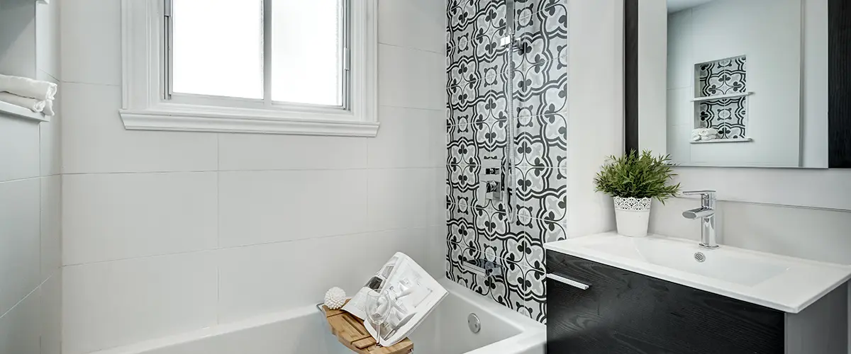 Basement bathroom with dark vanity and tub