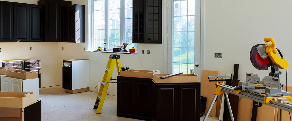 Black kitchen cabinets installation in progress