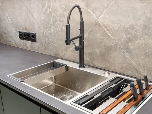 Black faucet on soap stone countertop