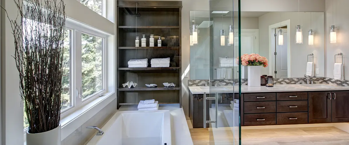 A bathroom remodel with a double wood vanity with glass shower and tub combo