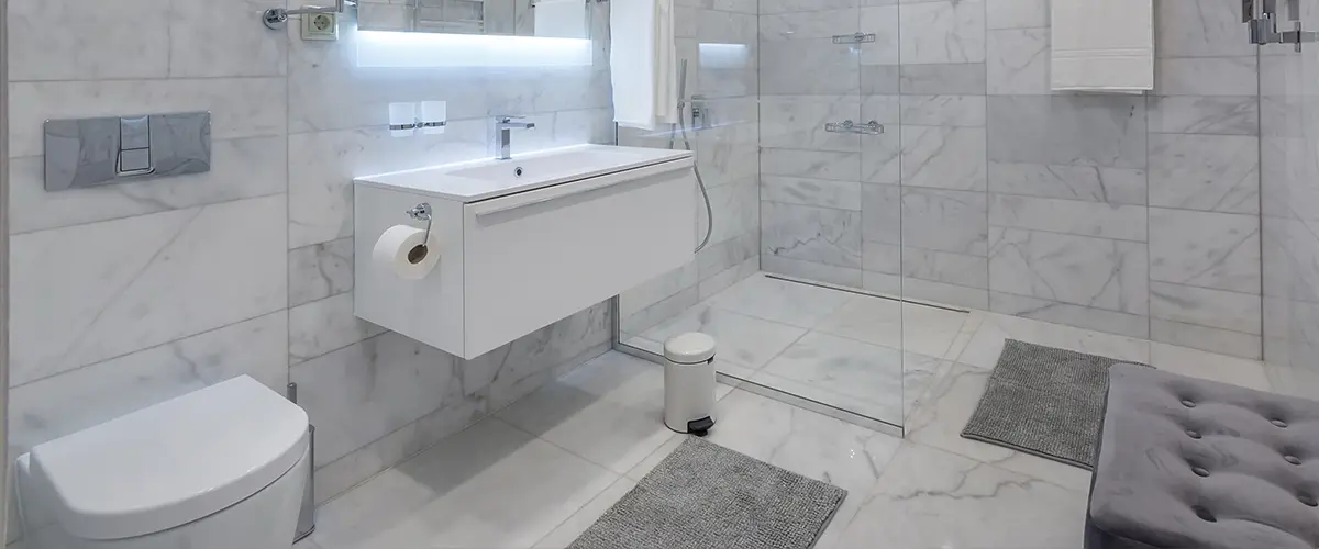 A modern sink and toilet in a white bathroom