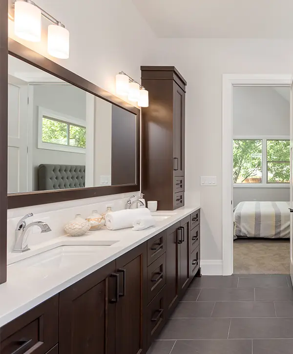 A wood vanity with cabinets and a white countertop