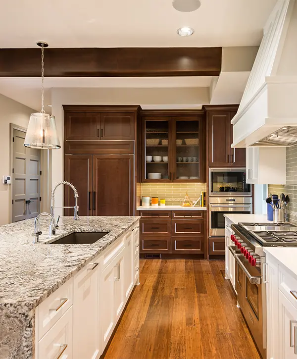Wood flooring with granite counter space and wood kitchen cabinets