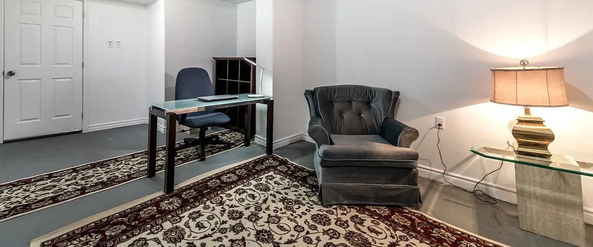 A finished basement made an office with carpet and a chair