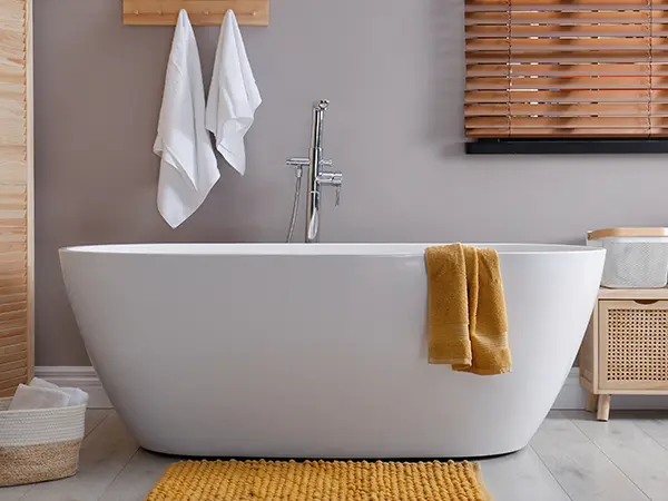 A freestanding tub with an orange carpet