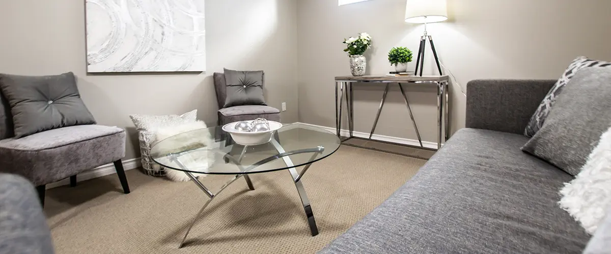 A basement remodel in Omaha made an office with a gray couch and chairs