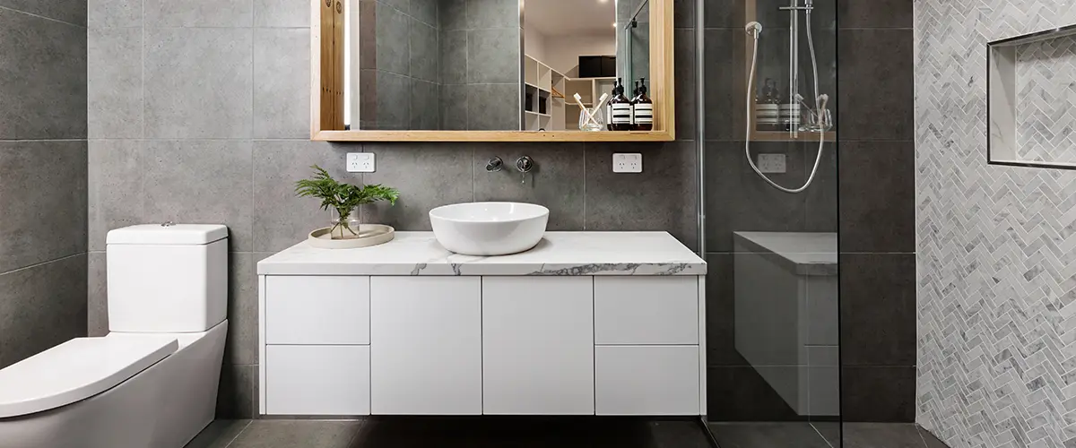 A modern bathroom with white slab vanity doors and tiled shower