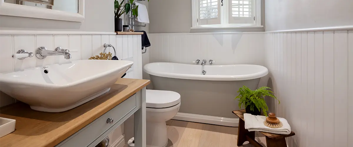 A traditional bathroom with a tub and a wood vanity top