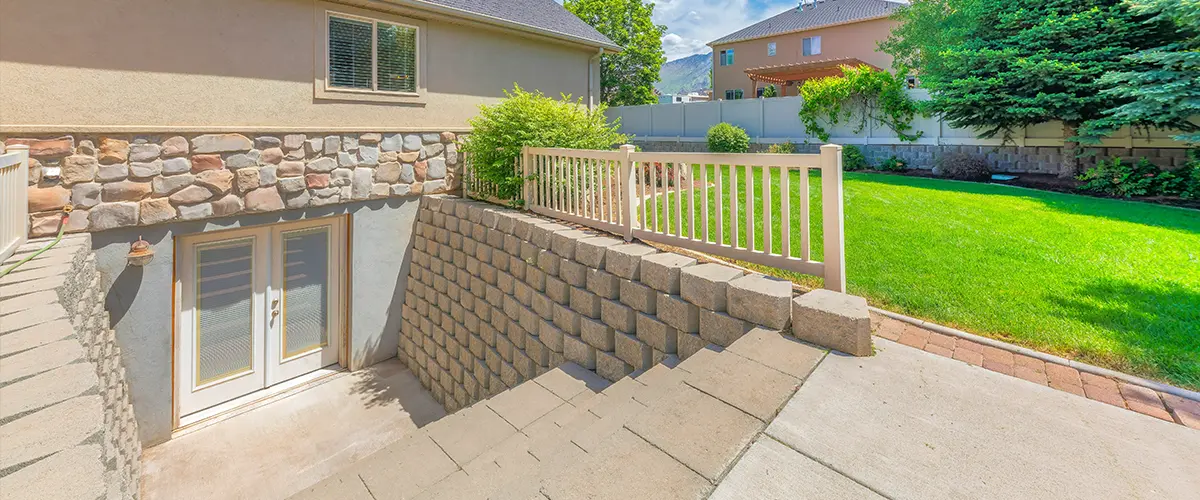 A walk-out basement with stairs and stone veneer on wall