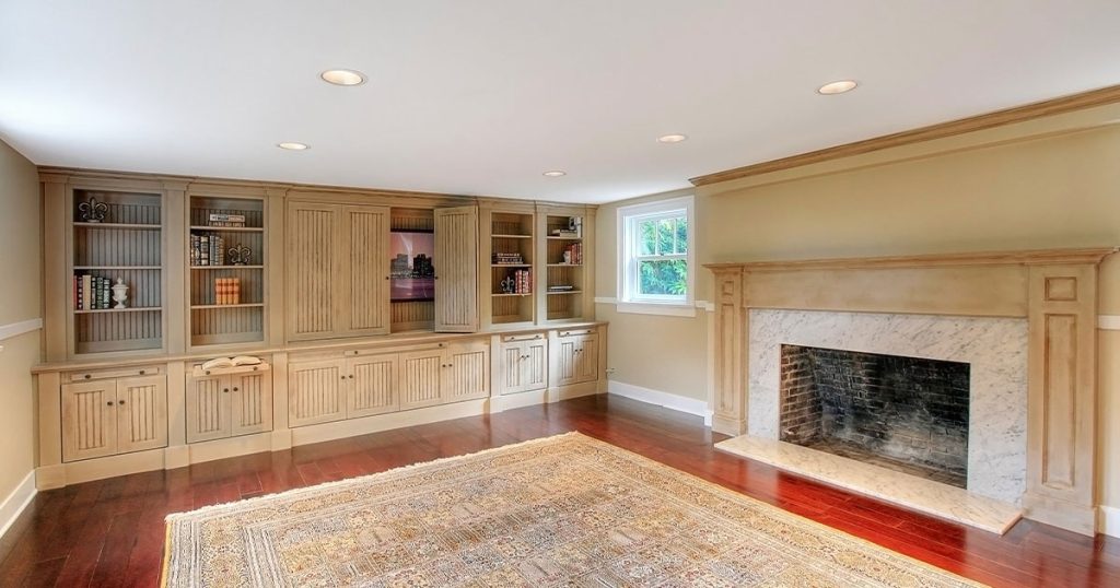 A basement remodel in Elkhorn with a fireplace and hardwood flooring