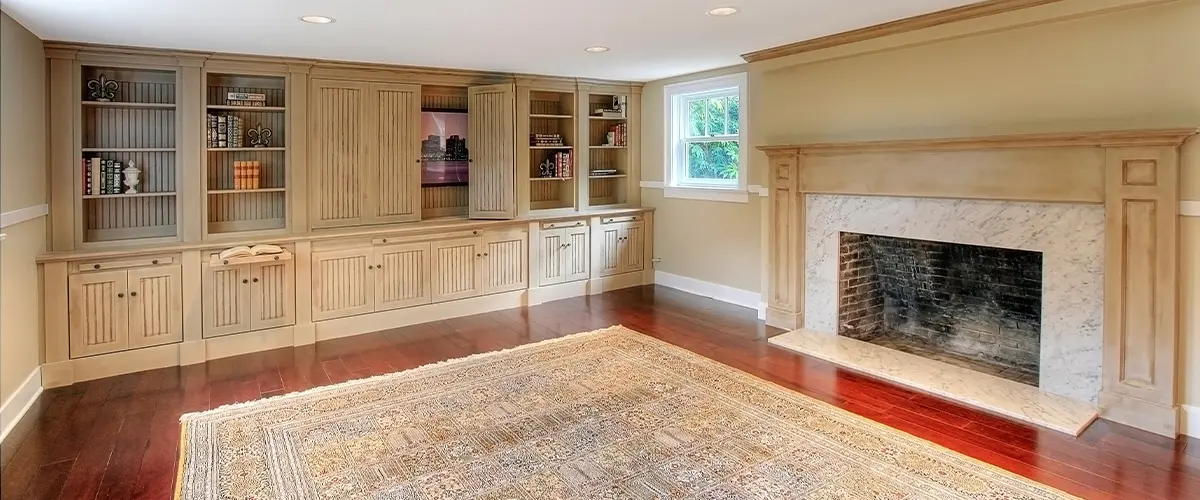 A basement remodel with a fireplace and hardwood flooring