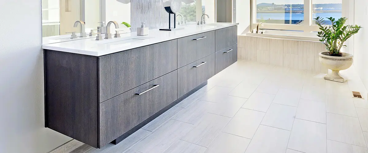 A double vanity made of wood with silver pulls in a bathroom remodel in Gretna