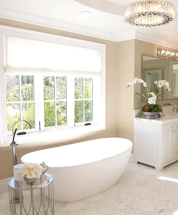 A freestanding tub underneath the window