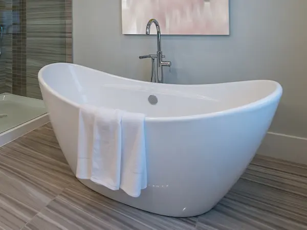 A freestanding tub with LVP flooring