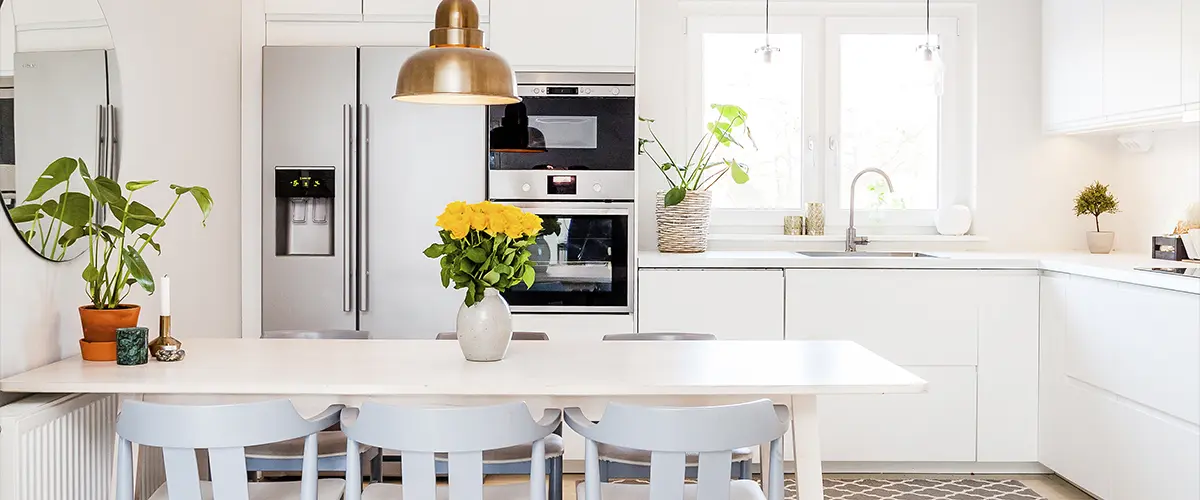 A kitchen with modern cabinets and plants