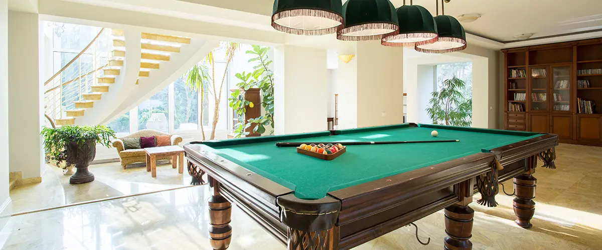 A pool table in a walkout basement