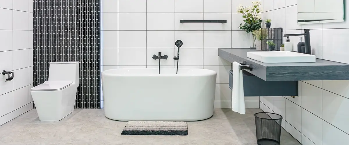 A bathroom space with a freestanding tub, a toilet, and a countertop with sink