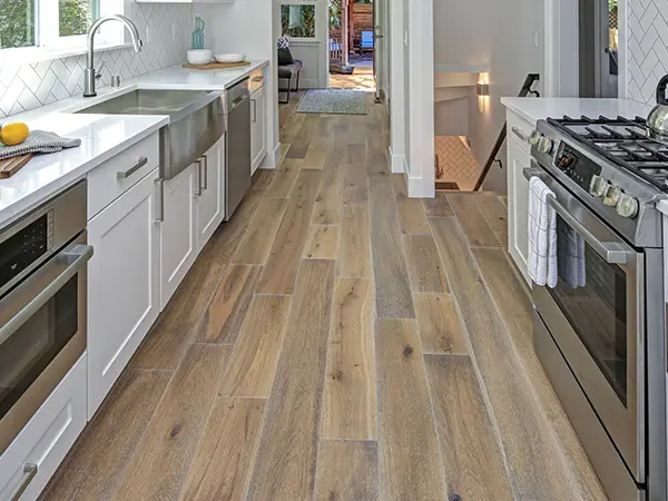 LVP flooring in a kitchen with white cabinets
