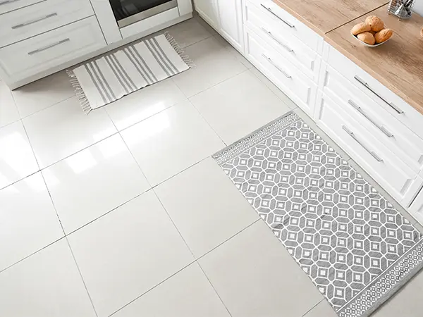 Porcelain tile flooring with two white matts
