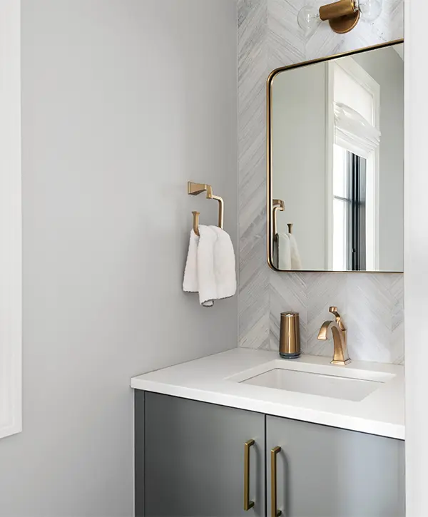 A gray vanity in a powder room