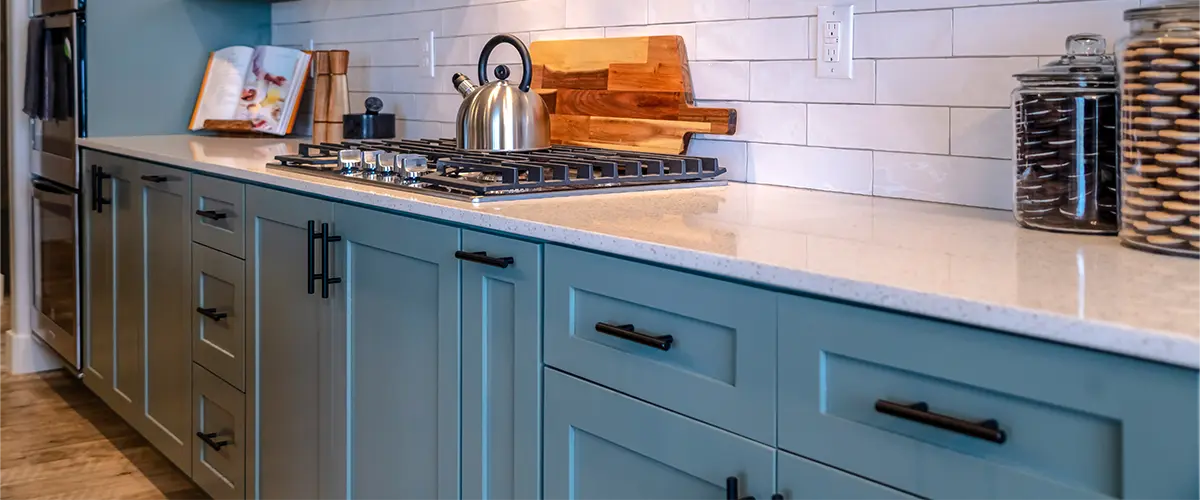 Blue base cabinets with white countertop