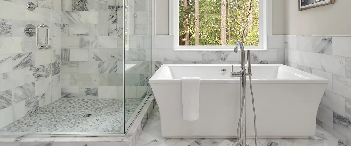 A tub and glass walk-in shower in a bathroom