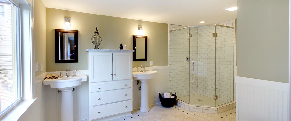 Elegant Papillion bathroom with best tile for shower walls, dual sinks, and white vanity.