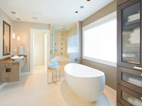 Bright bathroom with freestanding tub, glass shower, and elegant fixtures for a relaxing and modern home spa experience.