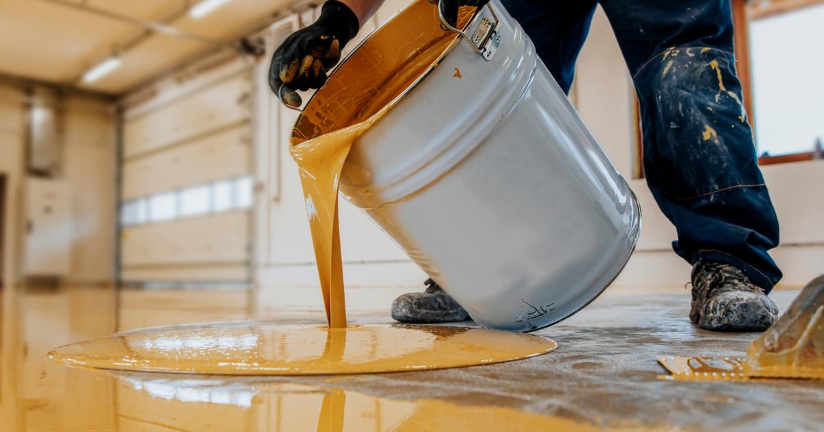 Yellow epoxy flooring being applied in a garage