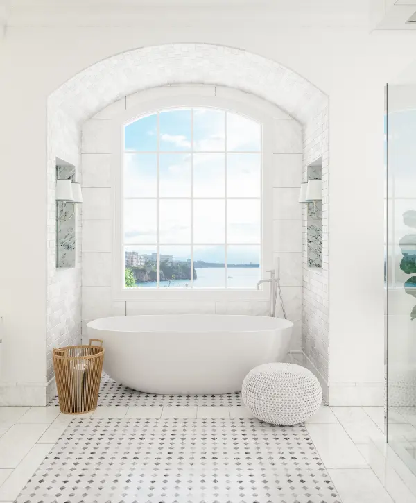 Bright bathroom with a freestanding tub and large window overlooking the water