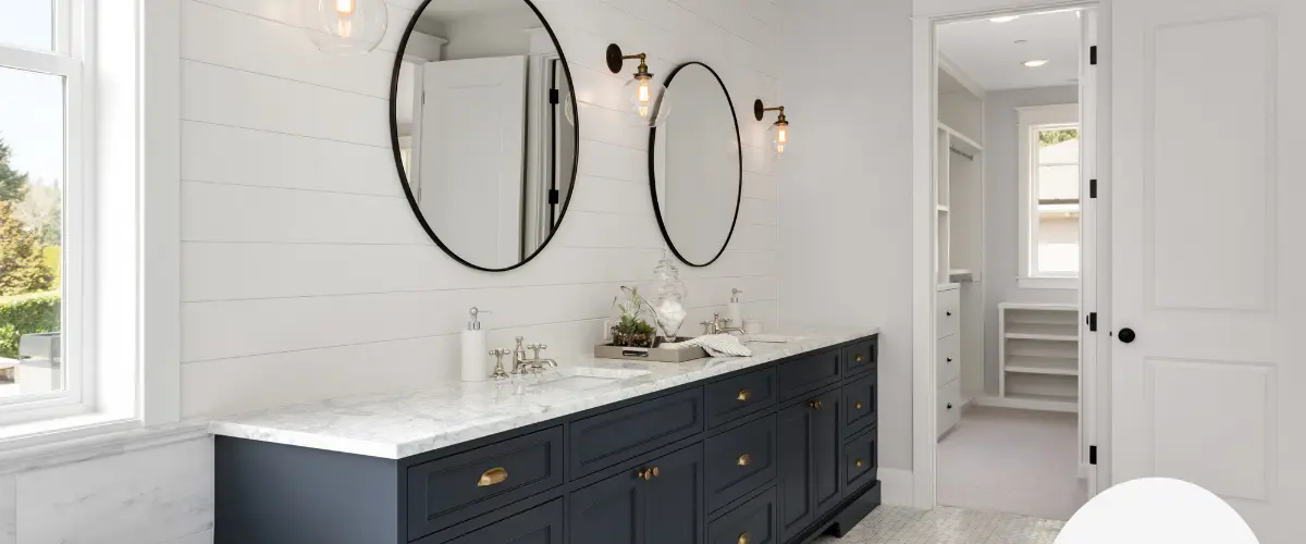 Elegant double vanity bathroom with dark cabinets and marble countertops