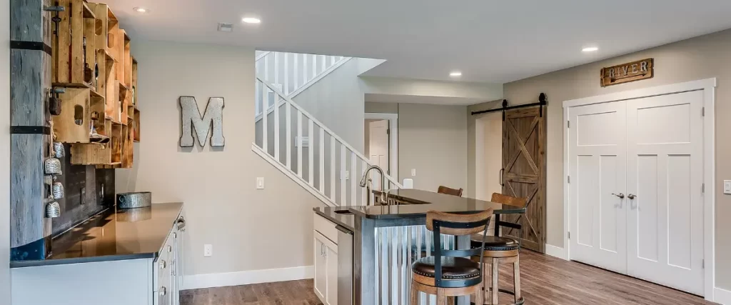 Basement bar area with corrugated metal island and wood accents