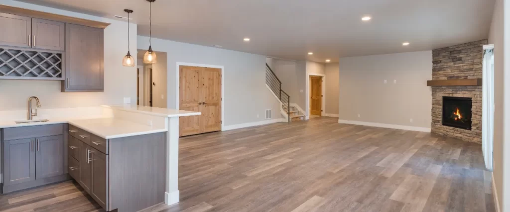 Spacious unfinished basement with wet bar and stone fireplace